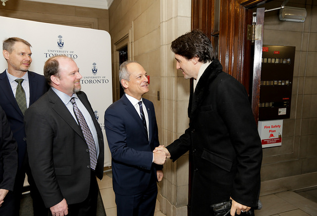 U of T President Meric Gertler greets Prime Minister Justin Trudeau as Prof. Peter Zandstra and Michael May look on.