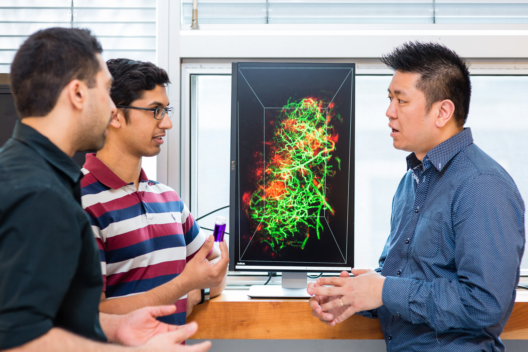 PhD candidates Abdullah Syed and Shrey Sindhwani in the lab of Professor Warren Chan (right)